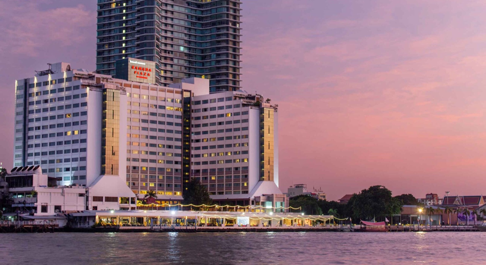 Ramada Plaza by Wyndham Bangkok Menam Riverside seen from the Chao Phraya River at dusk